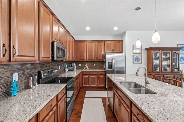 1181 Castlevecchio Loop, Orlando, FL 32825 - kitchen with appliances with stainless steel finishes, brown cabinetry, light stone countertops, tasteful backsplash, and a textured ceiling