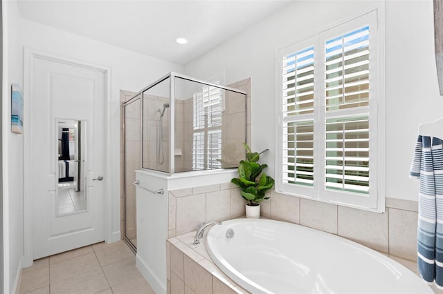 1181 Castlevecchio Loop, Orlando, FL 32825 - full bathroom with a garden tub, a shower stall, and tile patterned flooring