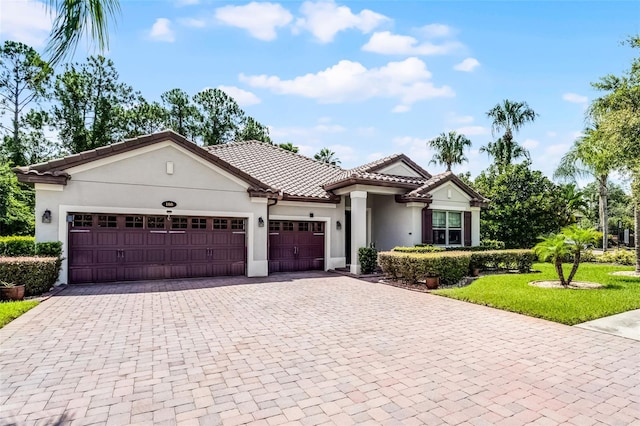 100 Verde Way, Debary, FL 32713 - view of front facade with decorative driveway, an attached garage, stucco siding, and a tiled roof