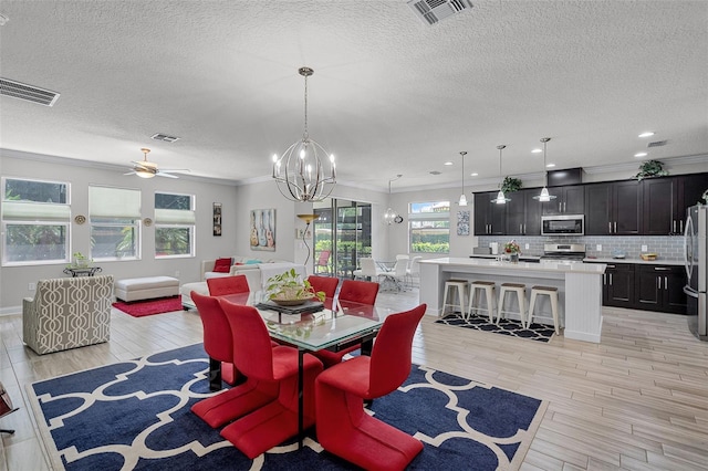 100 Verde Way, Debary, FL 32713 - dining room featuring crown molding, a textured ceiling, a chandelier, light wood-type flooring, and a ceiling fan