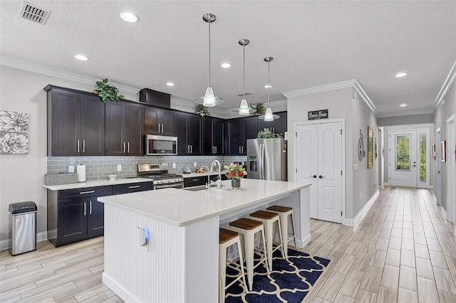100 Verde Way, Debary, FL 32713 - kitchen featuring stainless steel appliances, tasteful backsplash, light countertops, wood tiled floors, and crown molding