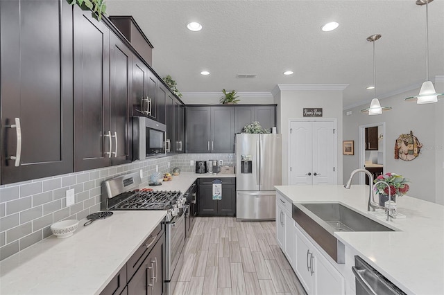 100 Verde Way, Debary, FL 32713 - kitchen with appliances with stainless steel finishes, backsplash, crown molding, decorative light fixtures, and a textured ceiling