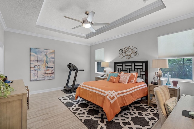 100 Verde Way, Debary, FL 32713 - bedroom with a tray ceiling, wood finished floors, a textured ceiling, crown molding, and a ceiling fan