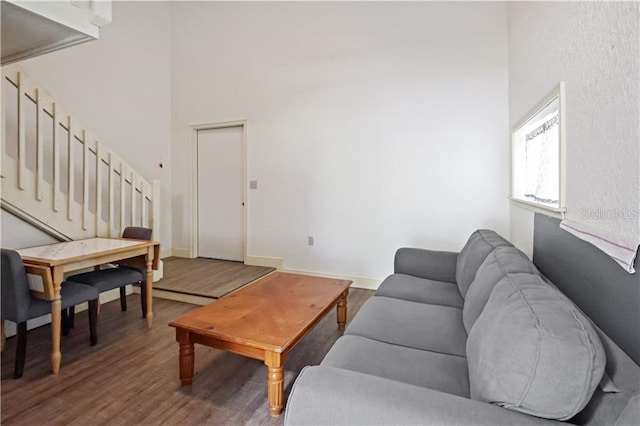 12350 83rd St, Fellsmere, FL 32948 - living room featuring stairs, wood finished floors, and a towering ceiling