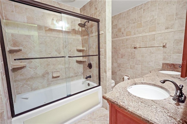 12350 83rd St, Fellsmere, FL 32948 - full bathroom with tile walls, double vanity, and bath / shower combo with glass door