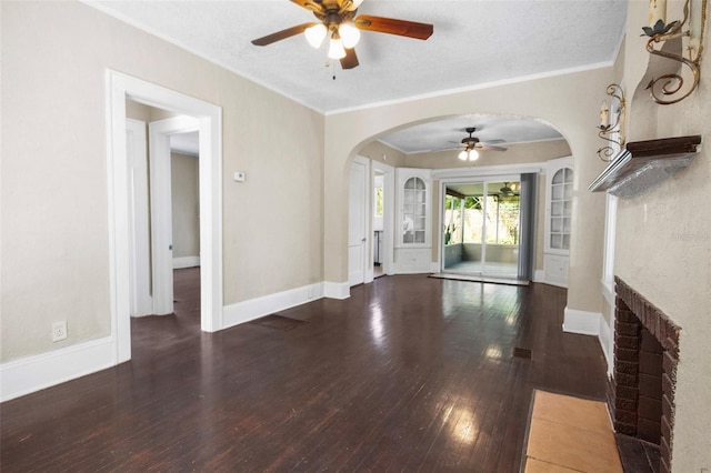 1215 6th St, Clermont, FL 34711 - unfurnished living room with ceiling fan, arched walkways, wood-type flooring, ornamental molding, and a fireplace