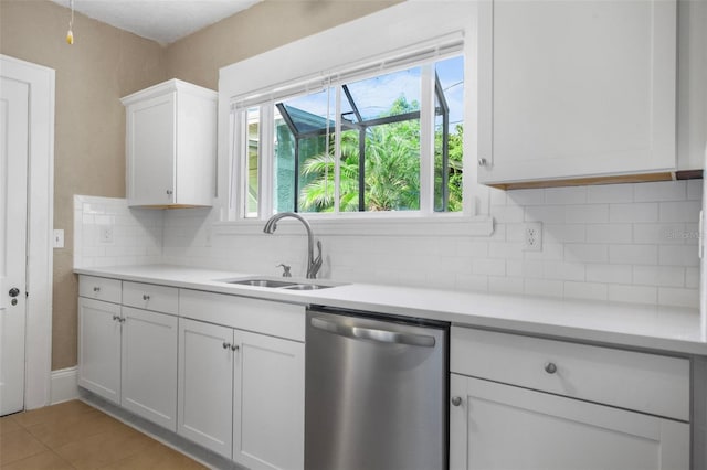 1215 6th St, Clermont, FL 34711 - kitchen with stainless steel dishwasher, light countertops, white cabinets, and backsplash