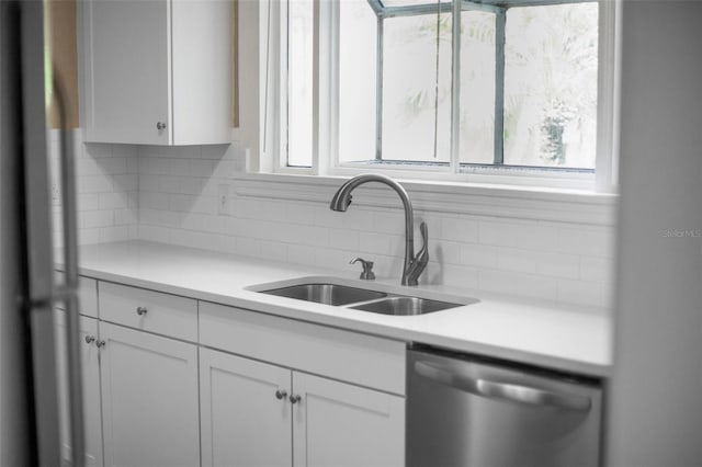 1215 6th St, Clermont, FL 34711 - kitchen featuring dishwasher, backsplash, white cabinets, and light countertops