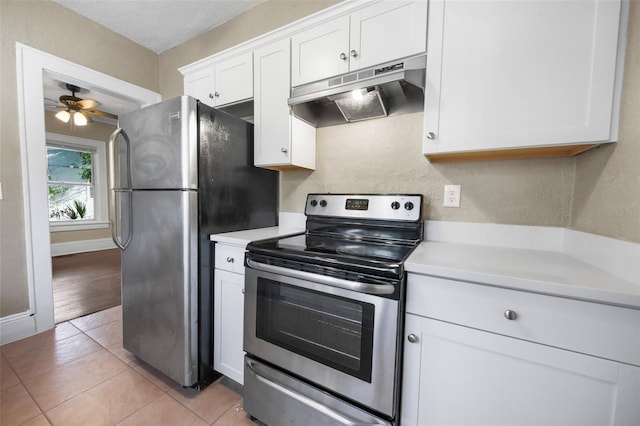 1215 6th St, Clermont, FL 34711 - kitchen with stainless steel appliances, under cabinet range hood, light countertops, and white cabinetry
