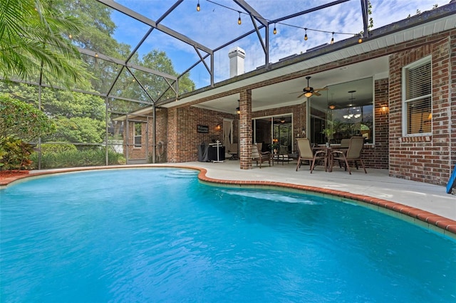 11613 Swift Water Cir, Orlando, FL 32817 - outdoor pool with a patio, ceiling fan, and glass enclosure