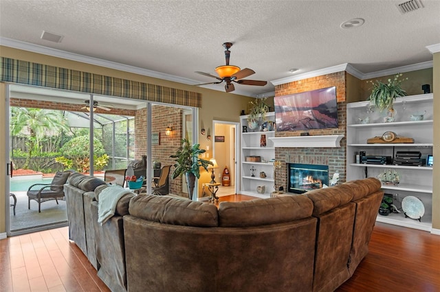 11613 Swift Water Cir, Orlando, FL 32817 - living area featuring ceiling fan, wood finished floors, crown molding, a fireplace, and a textured ceiling