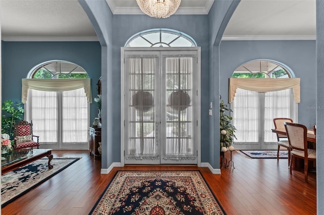 11613 Swift Water Cir, Orlando, FL 32817 - foyer featuring arched walkways, healthy amount of natural light, wood-type flooring, a chandelier, and ornamental molding