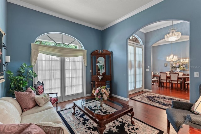 11613 Swift Water Cir, Orlando, FL 32817 - living area featuring a chandelier, ornamental molding, arched walkways, and wood finished floors