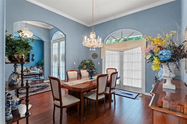 11613 Swift Water Cir, Orlando, FL 32817 - dining room featuring a chandelier, ornamental molding, dark wood finished floors, and arched walkways
