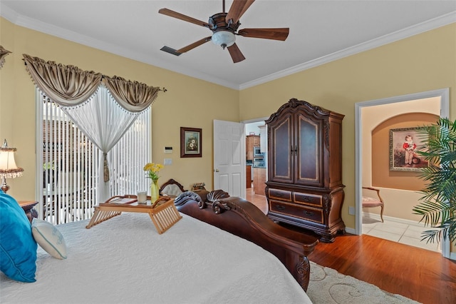 11613 Swift Water Cir, Orlando, FL 32817 - bedroom with access to outside, crown molding, wood finished floors, a ceiling fan, and ensuite bathroom