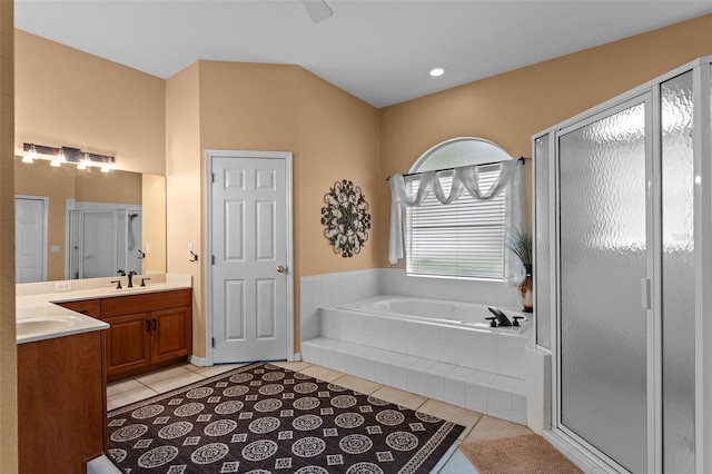 11613 Swift Water Cir, Orlando, FL 32817 - full bathroom featuring tile patterned flooring, vanity, a garden tub, and a shower stall
