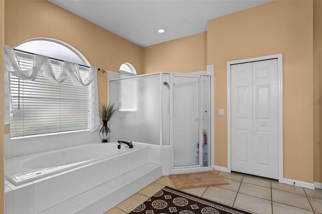 11613 Swift Water Cir, Orlando, FL 32817 - full bath with a shower stall, a garden tub, tile patterned flooring, and a closet