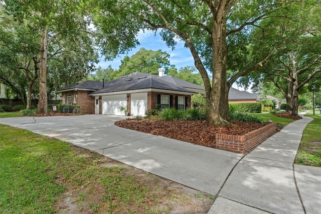 11613 Swift Water Cir, Orlando, FL 32817 - ranch-style home with a garage, brick siding, driveway, and a front yard