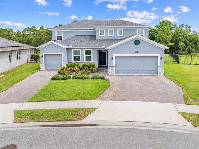 2412 Camden Park Ave, Davenport, FL 33837 - view of front of home featuring stucco siding, stone siding, driveway, an attached garage, and roof with shingles