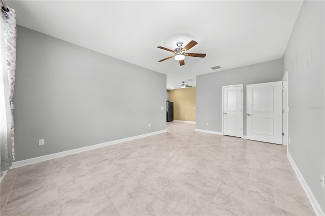 2412 Camden Park Ave, Davenport, FL 33837 - unfurnished bedroom with a ceiling fan and freestanding refrigerator