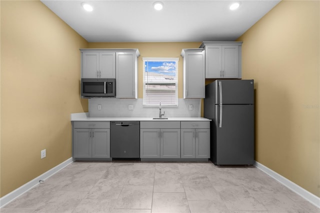 2412 Camden Park Ave, Davenport, FL 33837 - kitchen with stainless steel appliances, gray cabinets, light countertops, tasteful backsplash, and recessed lighting
