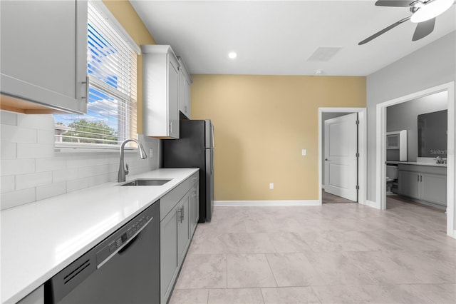 2412 Camden Park Ave, Davenport, FL 33837 - kitchen with stainless steel appliances, backsplash, light countertops, a ceiling fan, and gray cabinetry