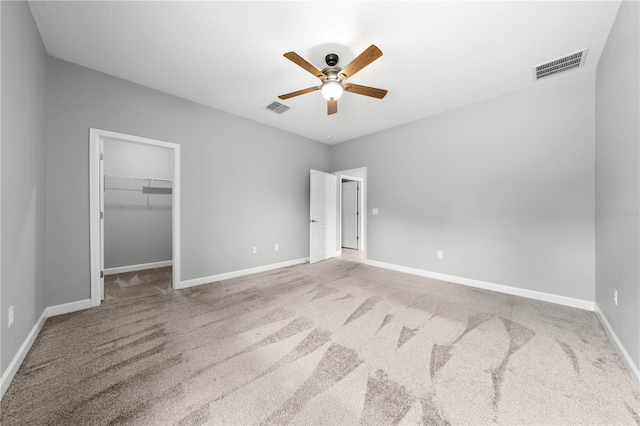 2412 Camden Park Ave, Davenport, FL 33837 - unfurnished bedroom with carpet, a spacious closet, and a ceiling fan