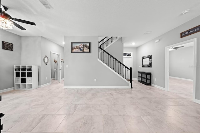 2412 Camden Park Ave, Davenport, FL 33837 - unfurnished living room with ceiling fan, stairs, recessed lighting, a textured ceiling, and tile patterned flooring