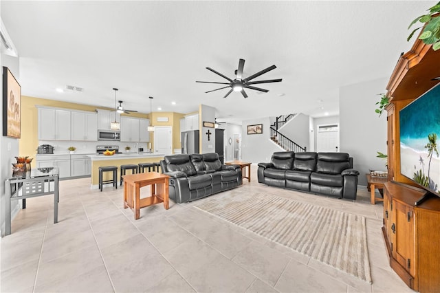2412 Camden Park Ave, Davenport, FL 33837 - living room with a ceiling fan, stairs, recessed lighting, and light tile patterned flooring
