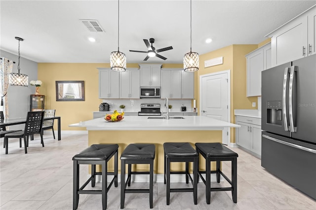 2412 Camden Park Ave, Davenport, FL 33837 - kitchen with appliances with stainless steel finishes, a kitchen breakfast bar, light countertops, ceiling fan, and recessed lighting