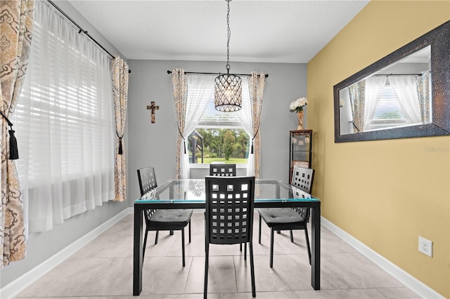 2412 Camden Park Ave, Davenport, FL 33837 - dining room with a chandelier and light tile patterned floors