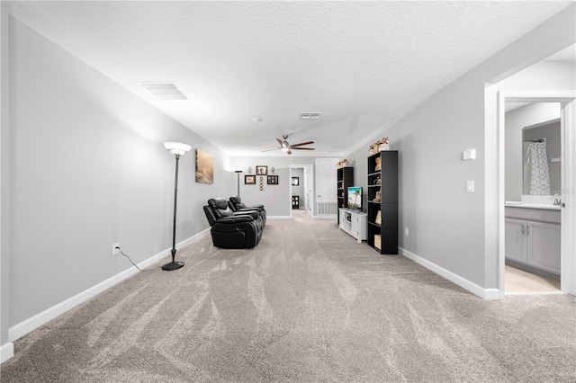 2412 Camden Park Ave, Davenport, FL 33837 - living area featuring light carpet, ceiling fan, and a textured ceiling