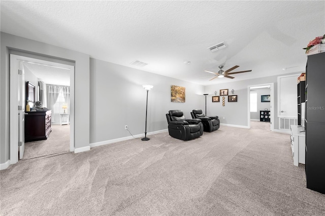 2412 Camden Park Ave, Davenport, FL 33837 - living area with light colored carpet, a ceiling fan, and a textured ceiling
