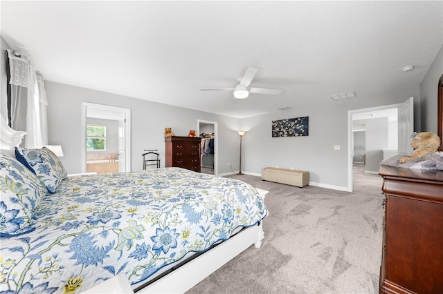 2412 Camden Park Ave, Davenport, FL 33837 - bedroom with carpet floors, a spacious closet, ceiling fan, ensuite bath, and a closet