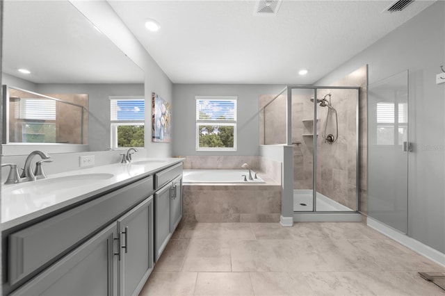 2412 Camden Park Ave, Davenport, FL 33837 - bathroom featuring a garden tub, double vanity, a stall shower, recessed lighting, and tile patterned floors