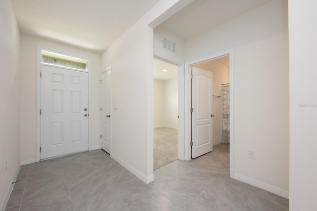 3241 Silas Dr, New Smyrna Beach, FL 32168 - foyer featuring light tile patterned floors and baseboards