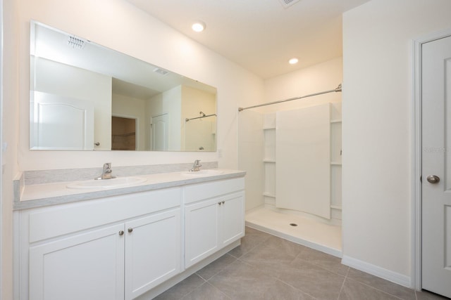 3241 Silas Dr, New Smyrna Beach, FL 32168 - bathroom with double vanity, a shower, and tile patterned flooring