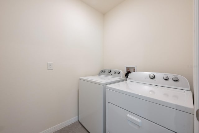3241 Silas Dr, New Smyrna Beach, FL 32168 - laundry room with washer and dryer and light tile patterned floors