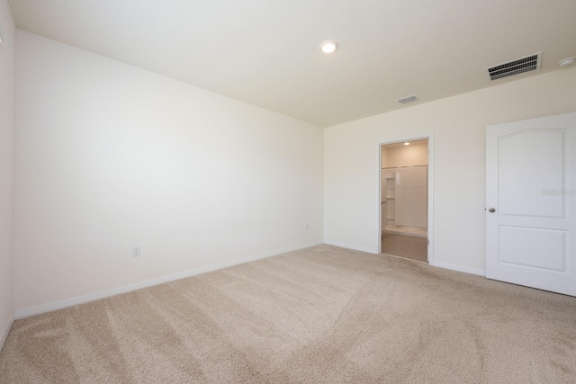 3241 Silas Dr, New Smyrna Beach, FL 32168 - unfurnished bedroom featuring carpet flooring, ensuite bathroom, and recessed lighting