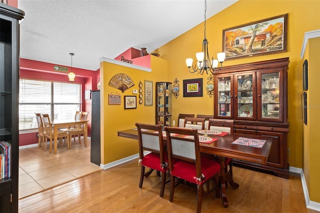1048 Woodsong Way, Clermont, FL 34714 - dining space with a chandelier, light wood-type flooring, and lofted ceiling