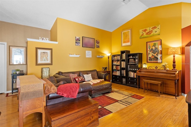 1048 Woodsong Way, Clermont, FL 34714 - living area with wood finished floors and vaulted ceiling
