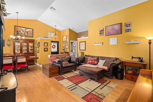 1048 Woodsong Way, Clermont, FL 34714 - living room with a chandelier, wood finished floors, and high vaulted ceiling