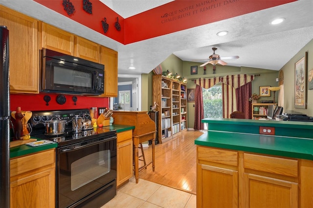 1048 Woodsong Way, Clermont, FL 34714 - kitchen featuring black appliances, ceiling fan, vaulted ceiling, light tile patterned floors, and a textured ceiling