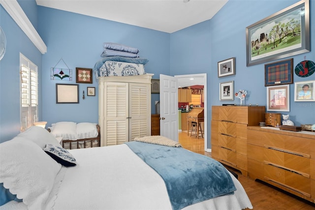 1048 Woodsong Way, Clermont, FL 34714 - bedroom featuring wood finished floors and a towering ceiling