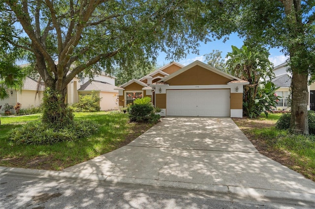 1048 Woodsong Way, Clermont, FL 34714 - view of front of house featuring driveway, an attached garage, and stucco siding