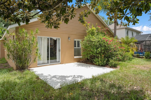 1048 Woodsong Way, Clermont, FL 34714 - back of property with a patio, stucco siding, and a yard