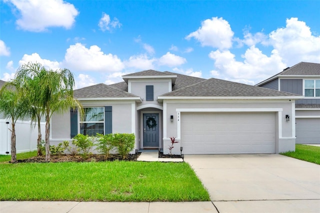 554 Pawnee Ct, Haines City, FL 33844 - view of front facade with a garage, roof with shingles, driveway, and a front yard