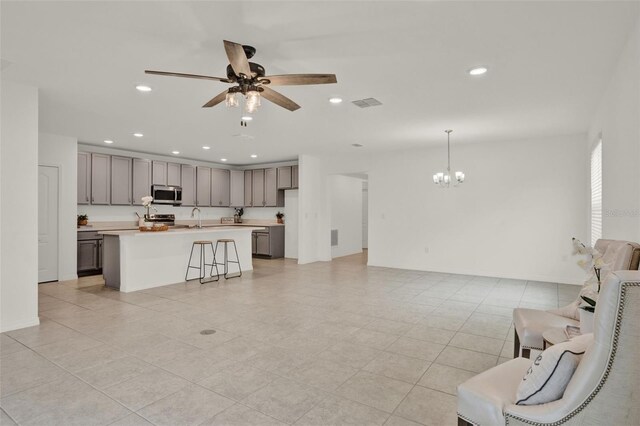 554 Pawnee Ct, Haines City, FL 33844 - living area featuring a chandelier, a ceiling fan, recessed lighting, and light tile patterned floors
