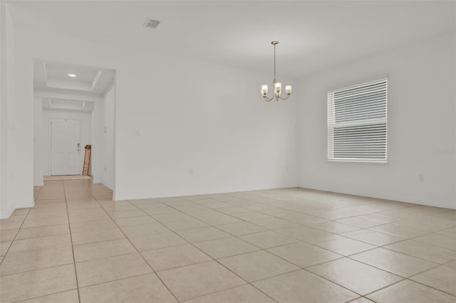 554 Pawnee Ct, Haines City, FL 33844 - empty room featuring a chandelier, light tile patterned floors, and a tray ceiling