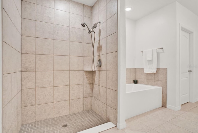 554 Pawnee Ct, Haines City, FL 33844 - bathroom featuring a stall shower, tile patterned flooring, and a bath